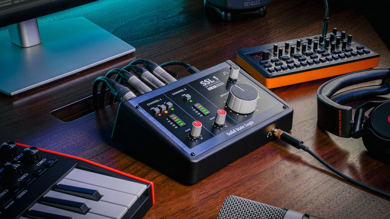 Solid State Logic SSL 1 audio interface review on a table with other recording equipement.