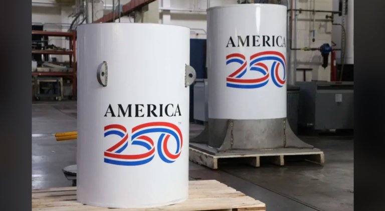 two white cylinders with an american flag and "america250" on them