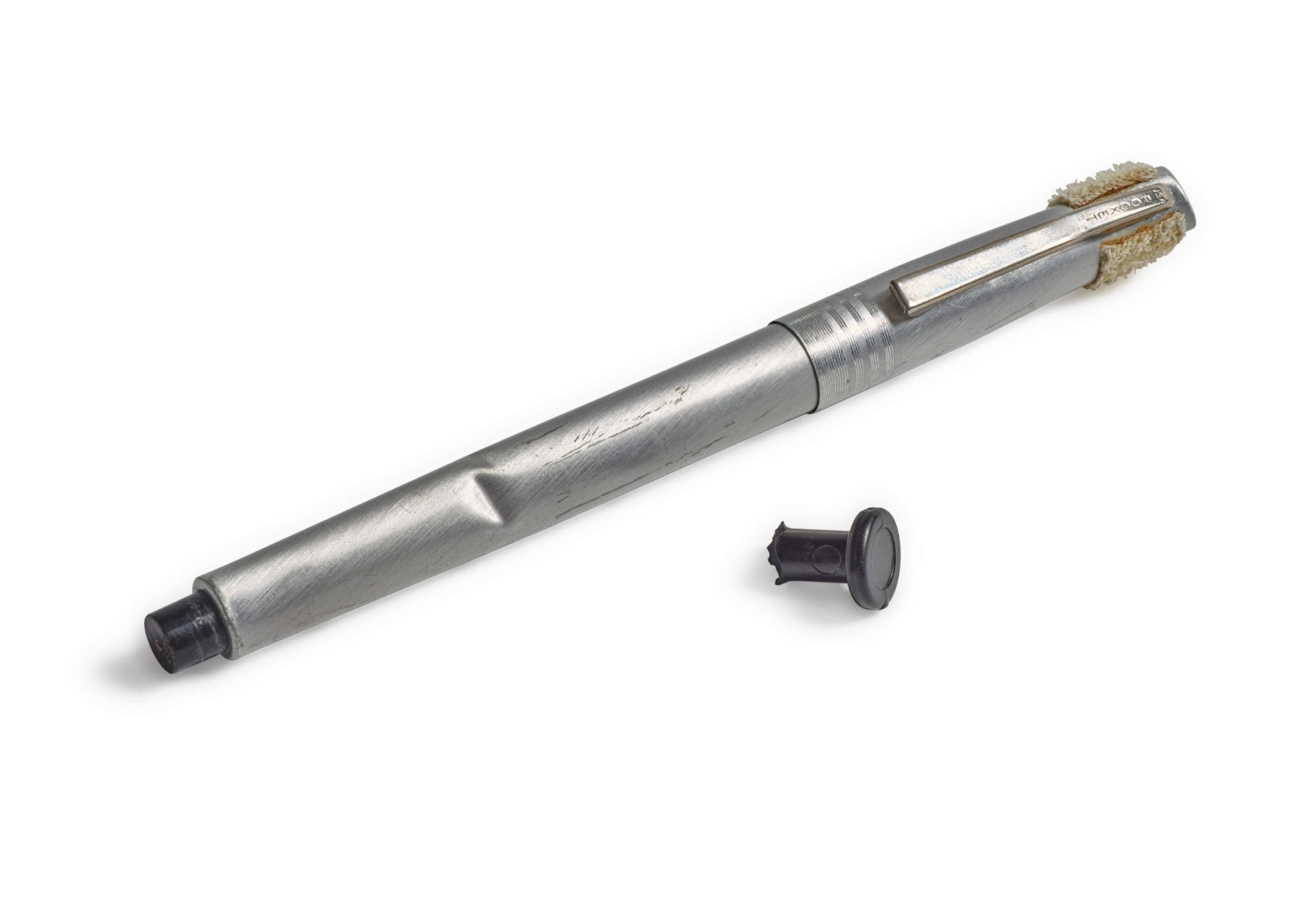 a silver pen next to a grey switch
