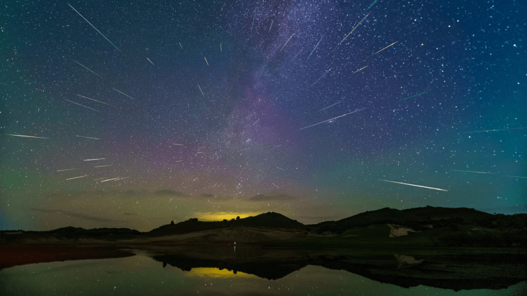 a meteor shower over grasslands