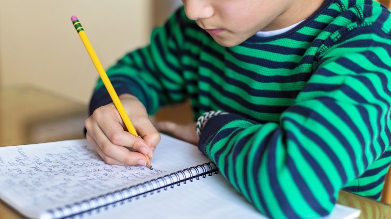 child writing cursive
