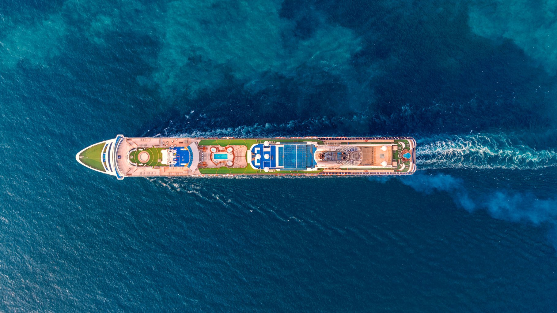 Aerial photo of passenger cruise ship at blue sea.