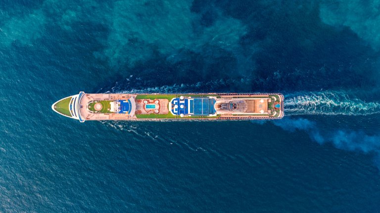 Aerial photo of passenger cruise ship at blue sea.
