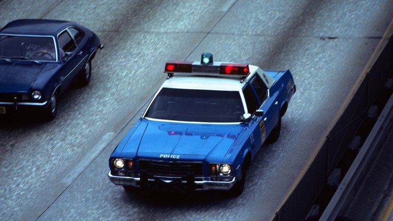 1970s BLUE AND WHITE NEW YORK CITY POLICE CAR ON HIGHWAY FROM ABOVE