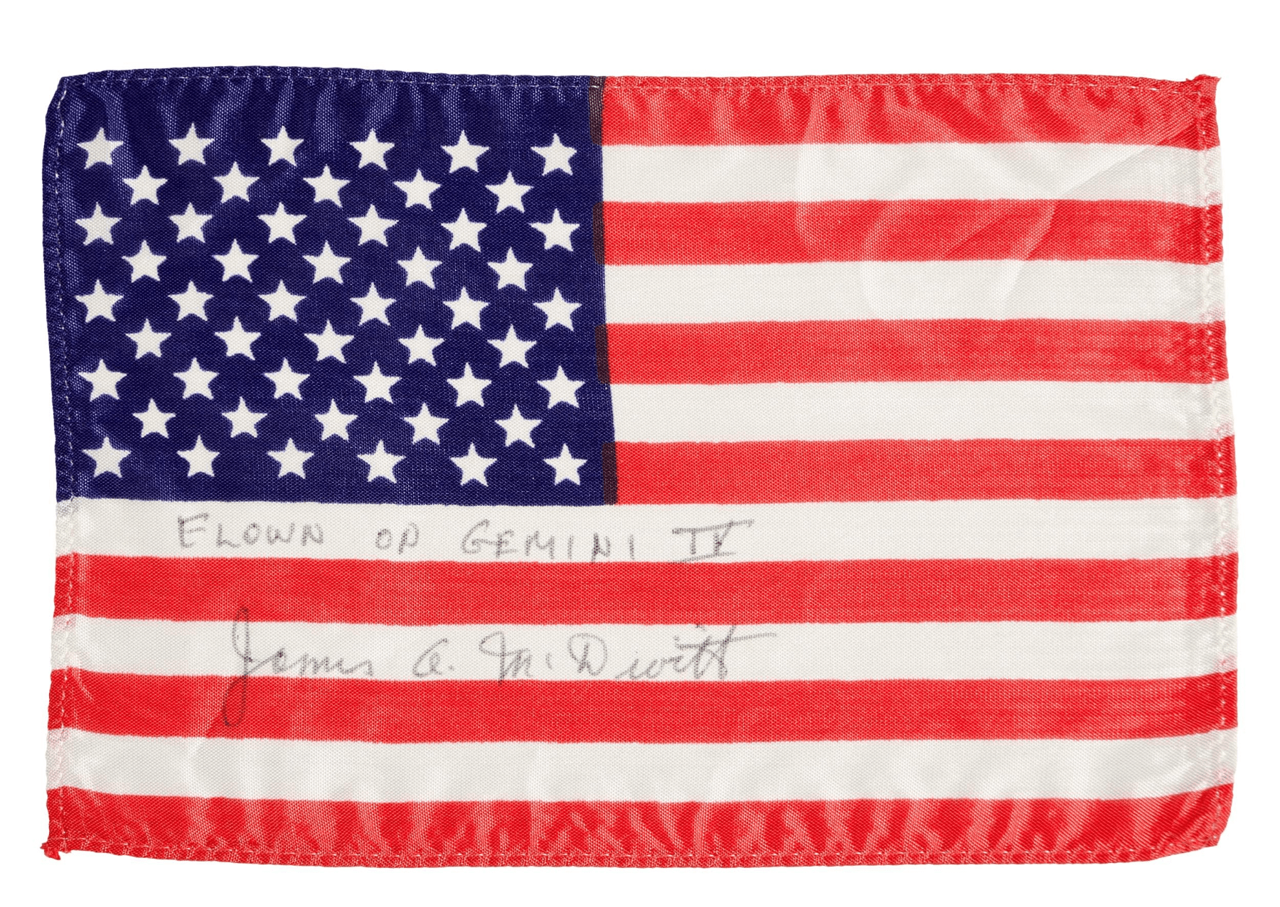 The Gemini IV flag is a silk stars and stripes flag and is signed and inscribed by McDivitt on the two lower white bars.