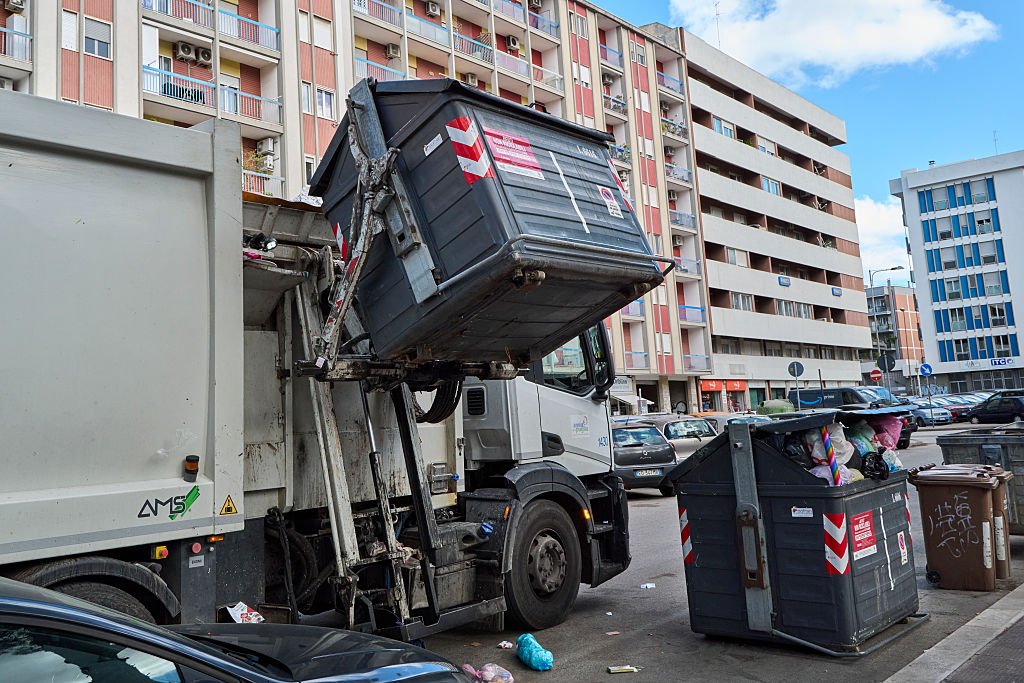 A garbage truck collects unsorted urban waste. The editorial image shows a garbage truck during the automated emptying of a bin containing unsorted municipal solid waste. The photo highlights the waste collection process in urban areas and the importance of efficient waste management systems to maintain city cleanliness and environmental sustainability in Bari, Italy, on October 8, 2025. (Photo by Matteo Della Torre/NurPhoto via Getty Images)