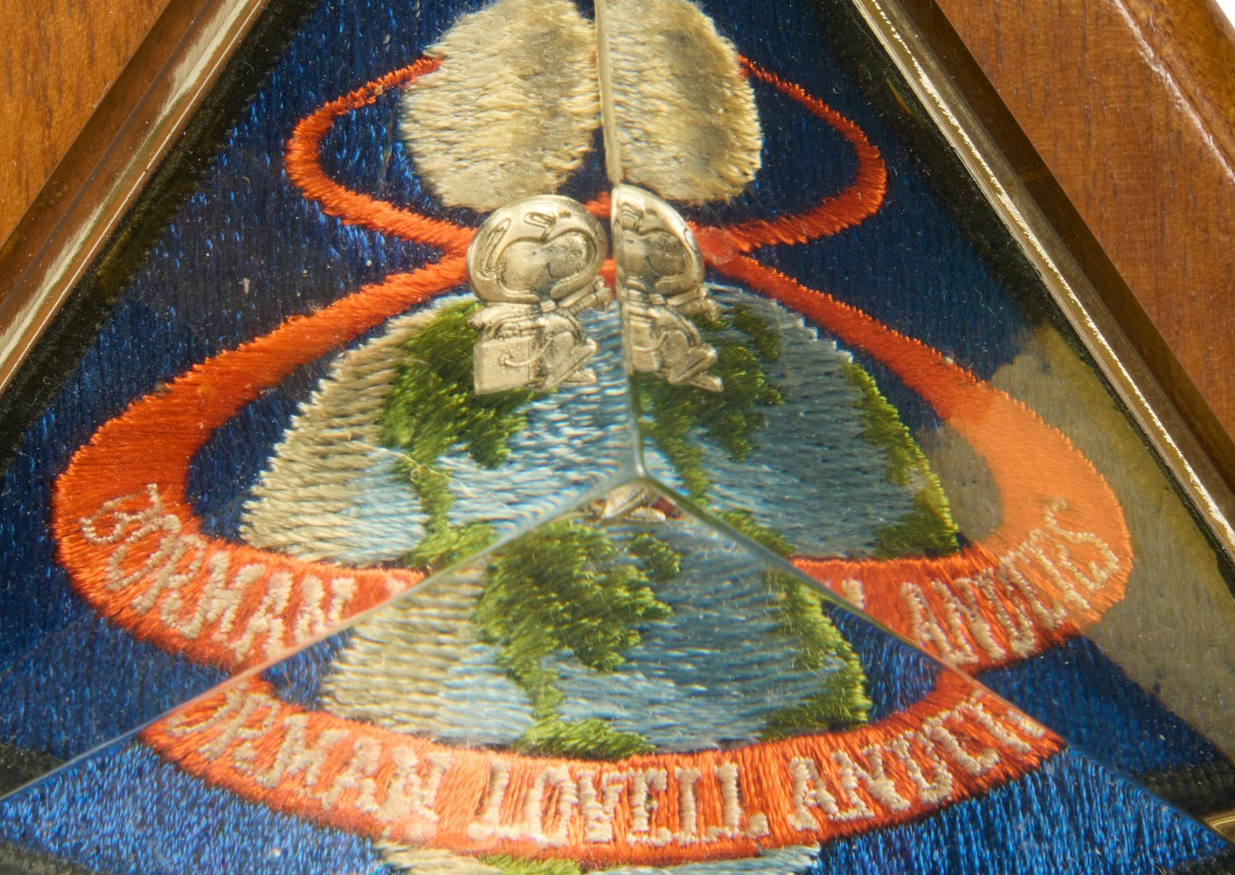 a silver pin of snoopy