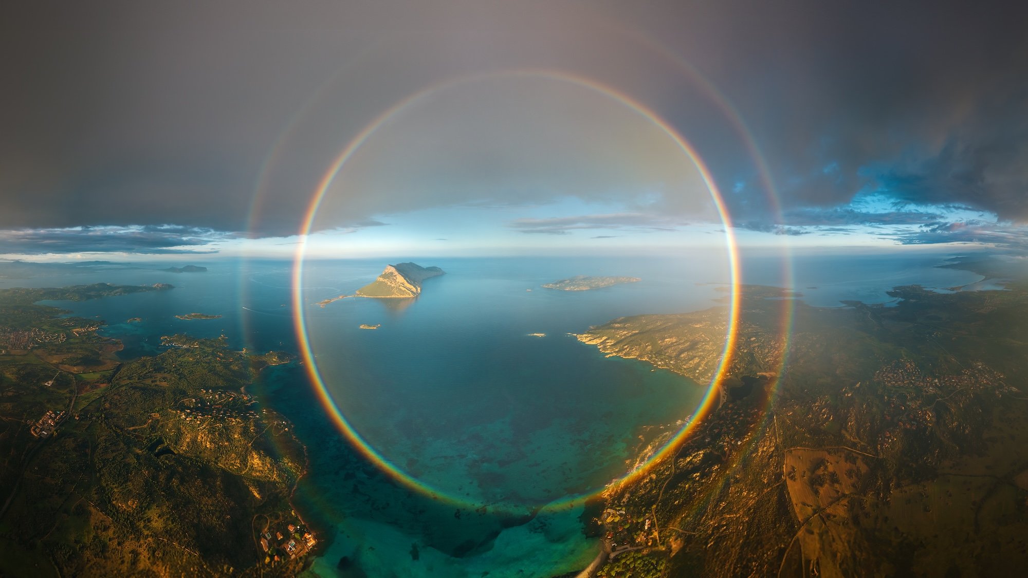 rainbow circle above islands