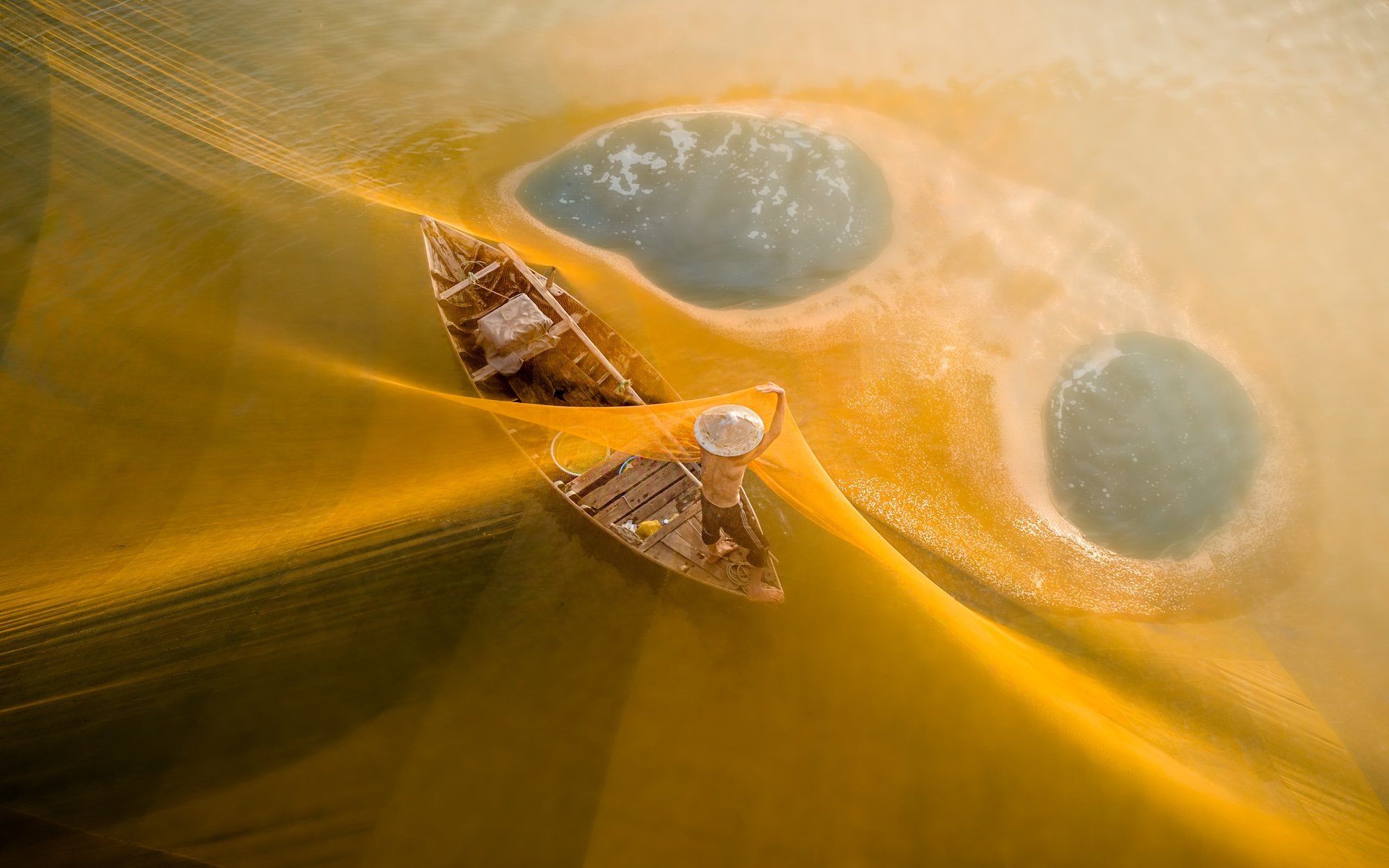 fisherman under a yellow net