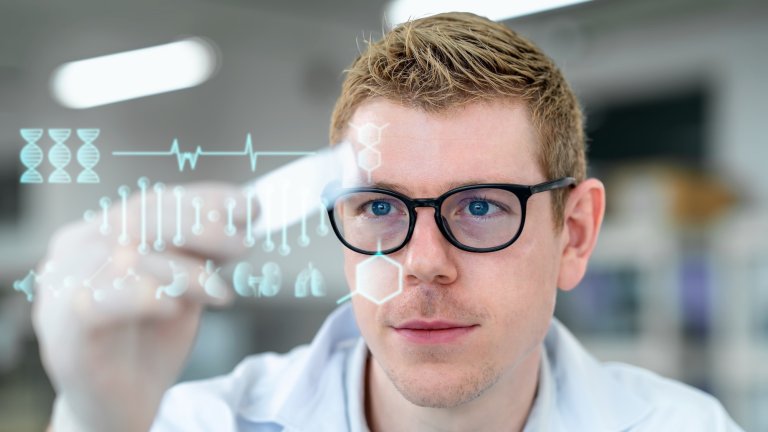 Watching to development. Male Chemist researcher or Scientist is holding a microscope slide and with digitization display of biotechnology in a laboratory.