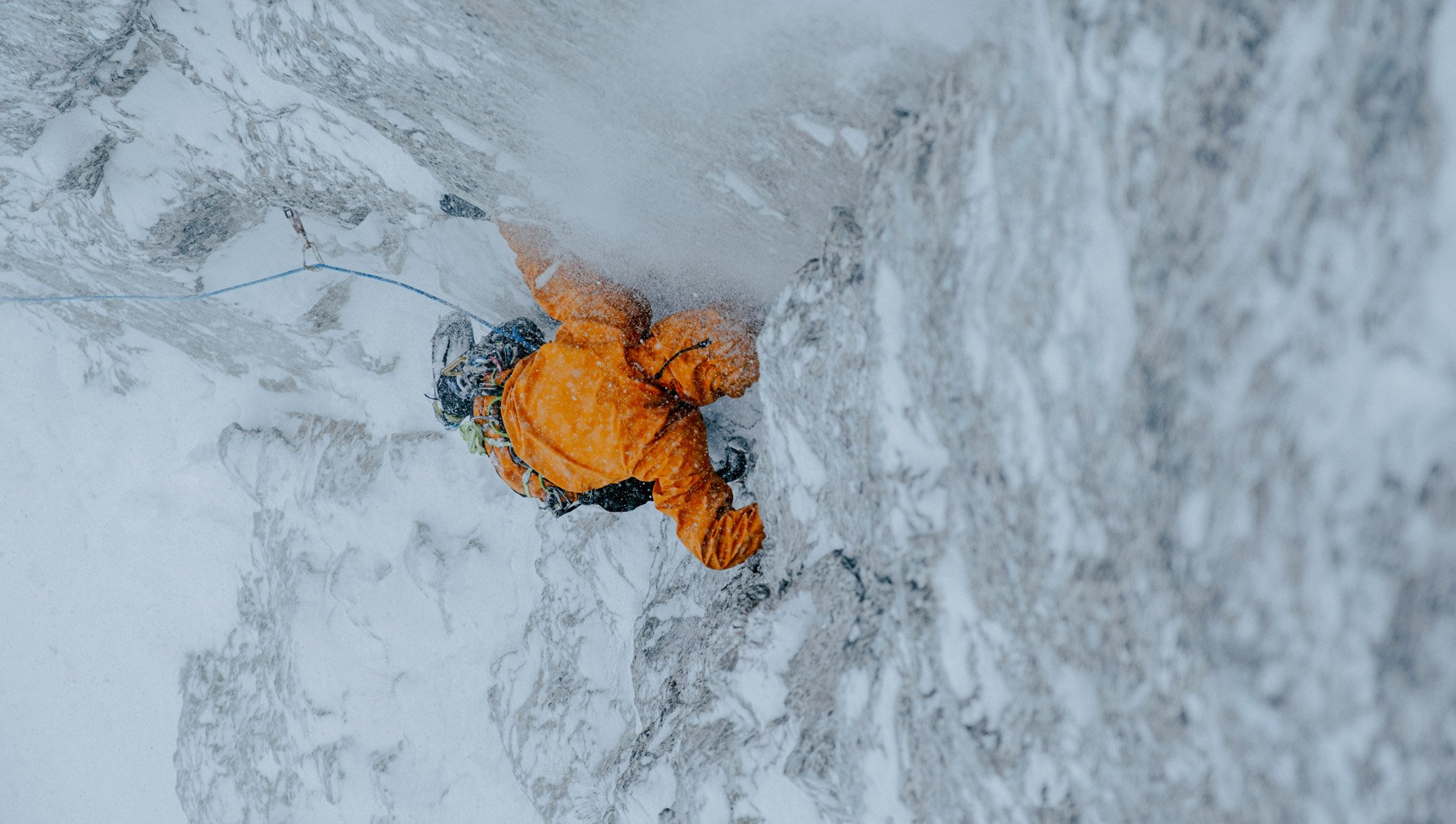 A person climbing an ice wall in an Arc'teryx Sperro SV jacket
