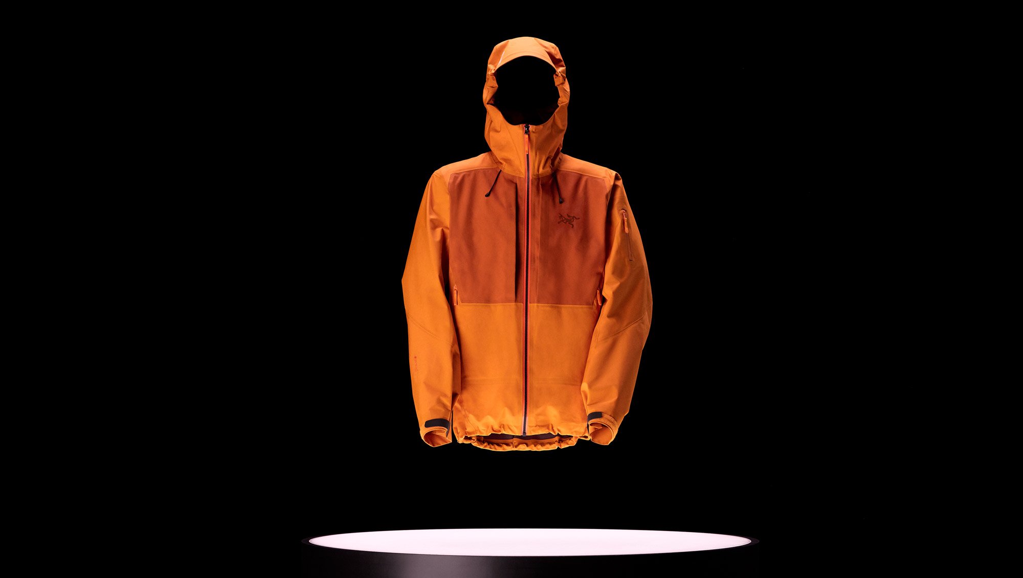 A Arc'teryx Sperro SV jacket on a black background with a light underneath it