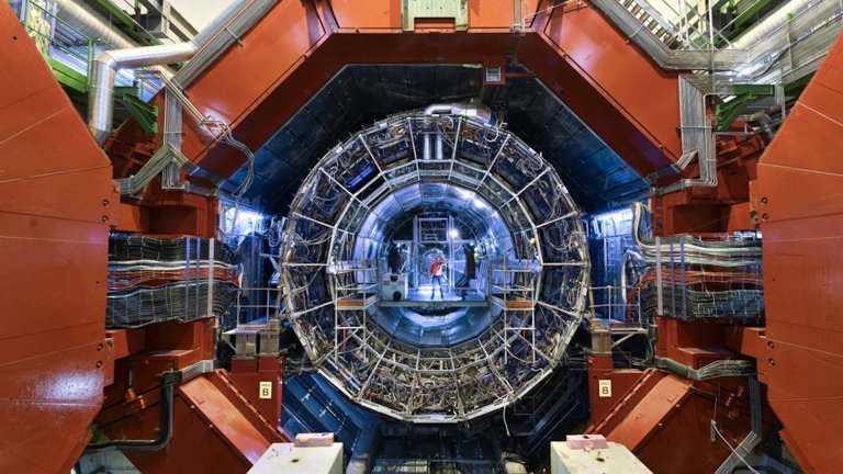 Scientists standing inside ALICE collider at CERN