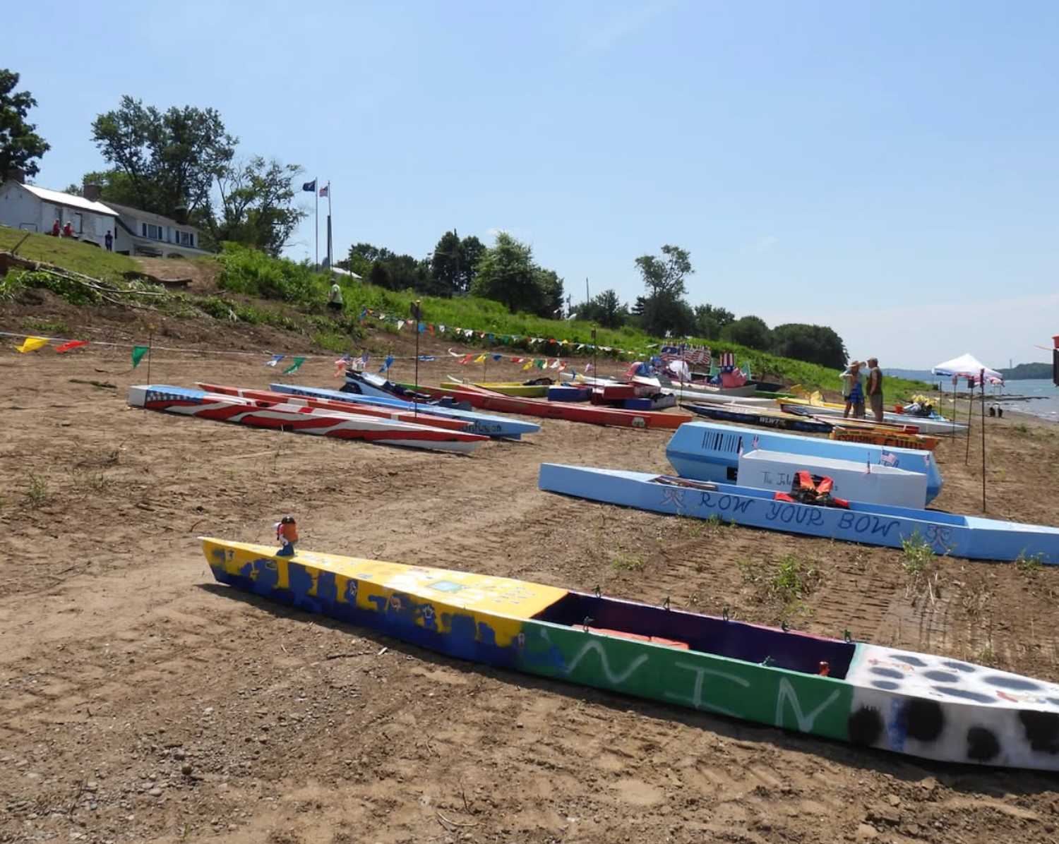 Cardboard boats on river shore