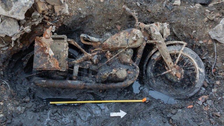 German DKW NZ 350-1 motorcycle remains excavated from Danube riverbed with measuring tape beneath it for size reference