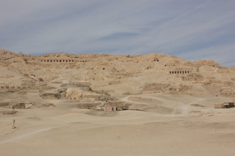 Wide panoramic view of the Valley of the Kings near Luxor, Egypt, featuring ancient royal tombs carved into the desert hills of the Theban Necropolis.