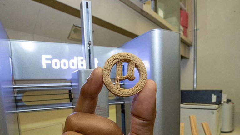 Hand holding 3D-printed cookie made from ingredients derived from plastic