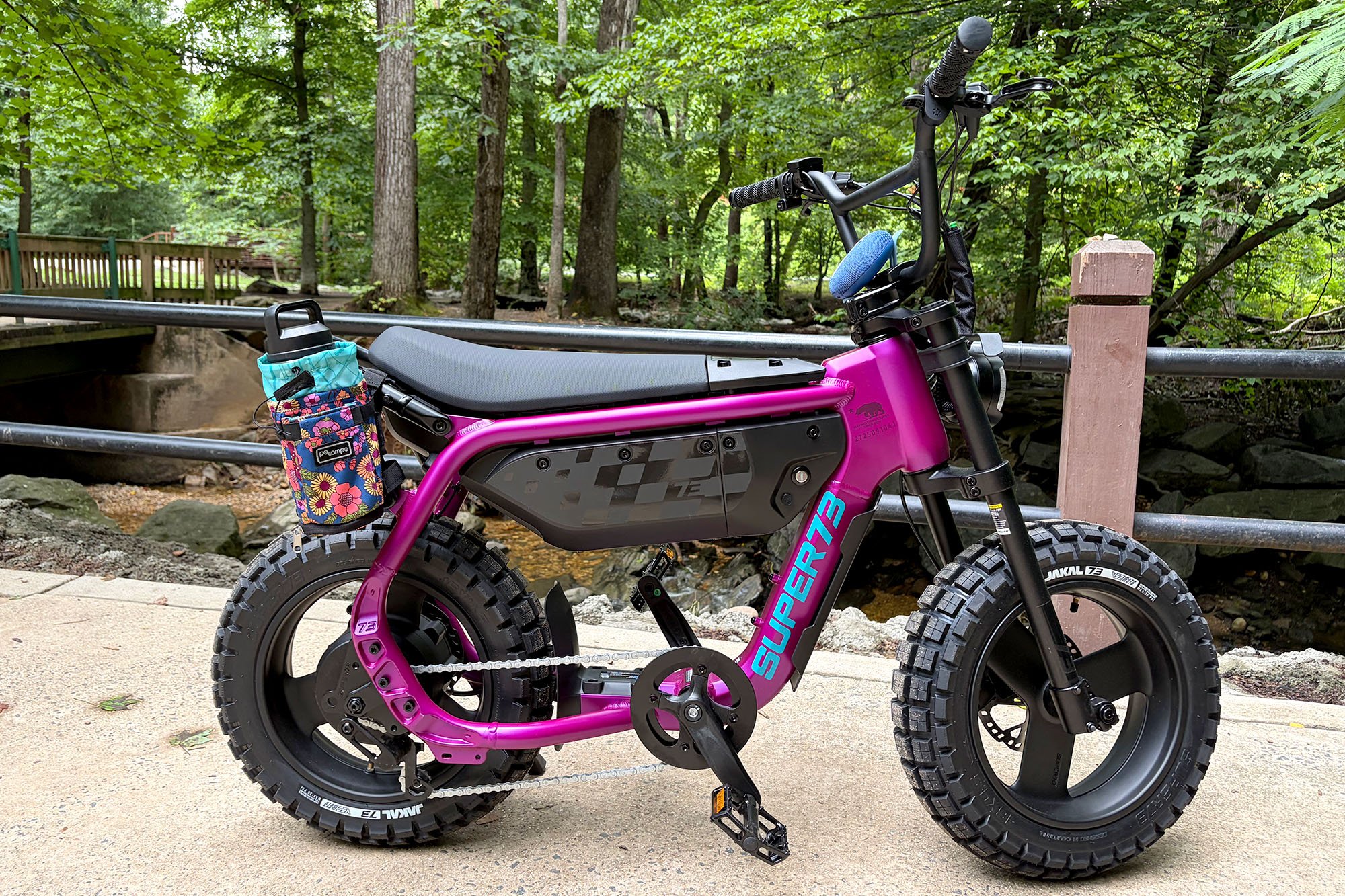 A Super73-MZT moto-style e-bike in Cullenberry shown from the side in a park