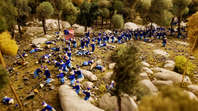 The Battle of Gettysburg, as depicted by clay cats. The 140th New York (right) arrives and the 20th Maine (left) charges, pushing the Confederates back. The fight eventually ends on Little Round Top.