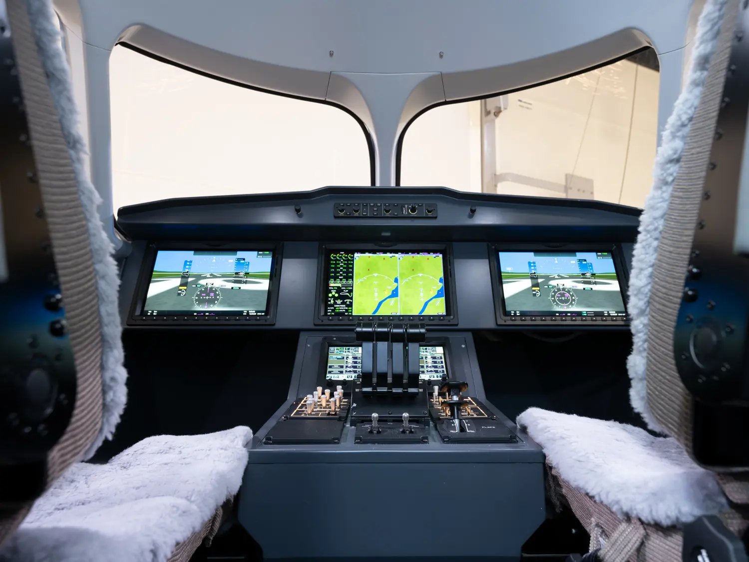 a mockup of a cockpit with two seats and a wide instrument panel