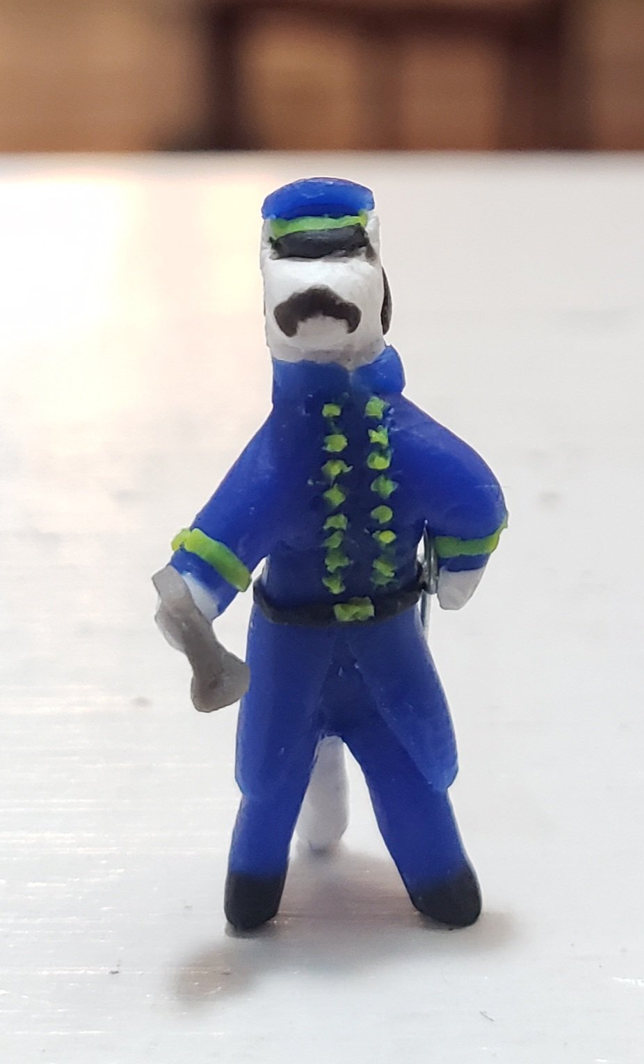 a cat made out of clay, with a brown mustache and blue union soldier uniform