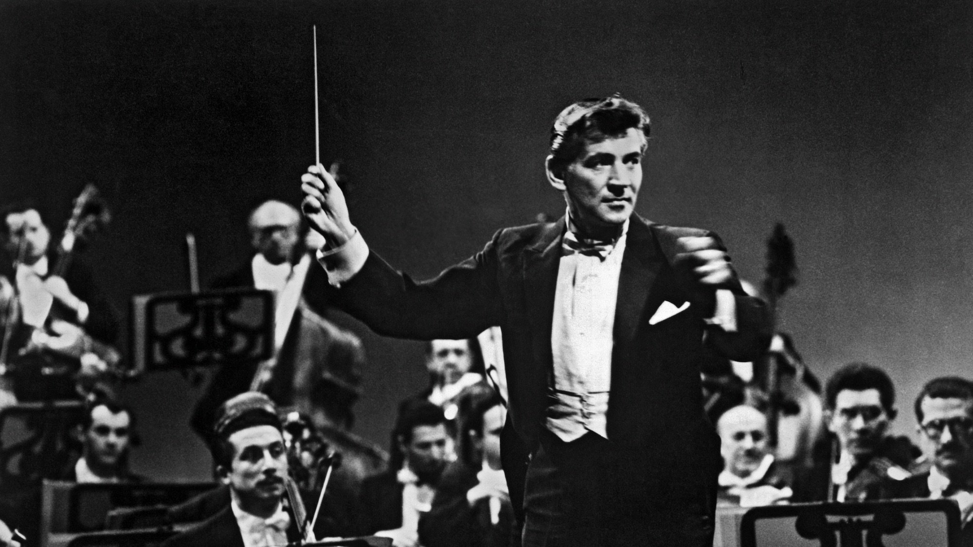 American composer, musician, and conductor Leonard Bernstein (1918 - 1990), of the New York Philharmonic, as he conducts and orchestra, New York, New York, January 1961. (Photo by Underwood Archives/Getty Images)