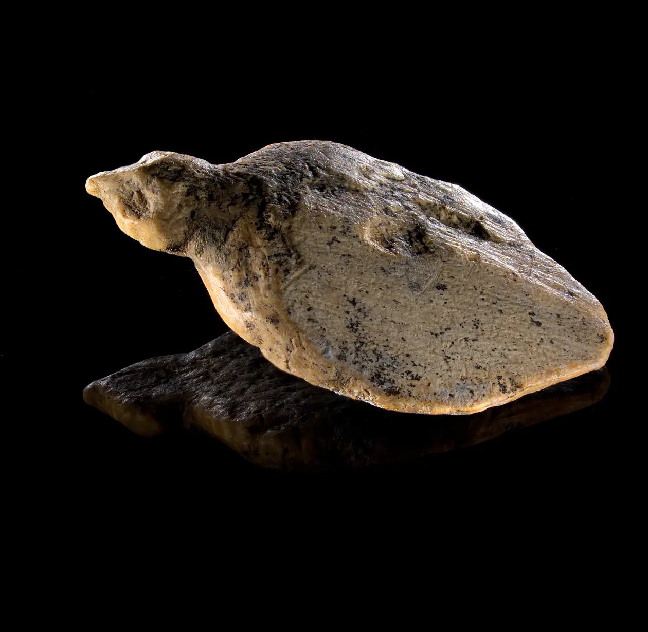 a carving of a bird lying down
