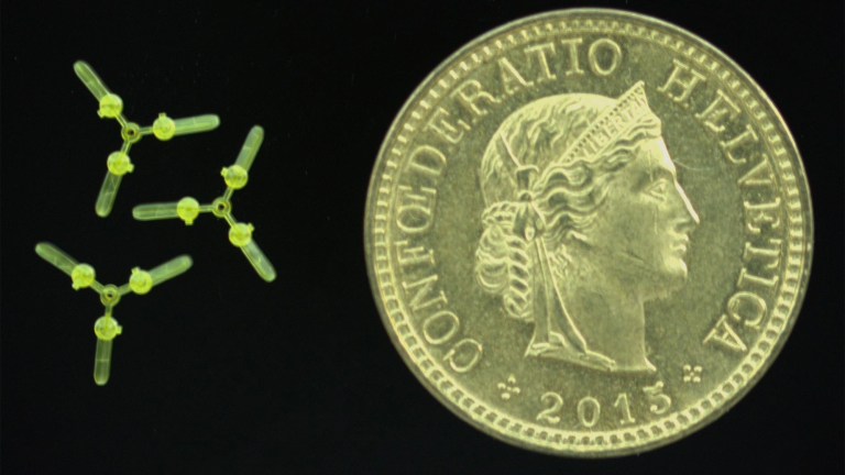 a small drone next to a coin