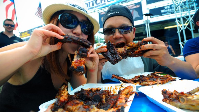 Man and woman eat ribs