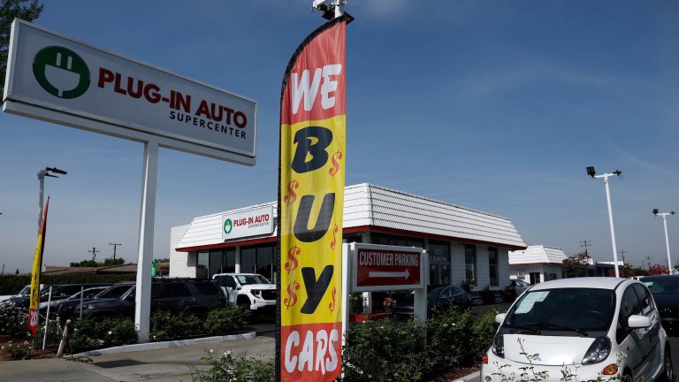 WEST COVINA, CALIFORNIA - MARCH 30: A used Mitsubishi i-MiEV electric vehicle is displayed on the sales lot at Plug-In Auto on March 30, 2026, in West Covina, California. As gas prices surge amid the war in Iran, online automotive resource Edmunds reported a 22% increase in searches for electric vehicles during the week of March 2, as motorists look for ways to avoid high fuel costs. (Photo by Justin Sullivan/Getty Images)