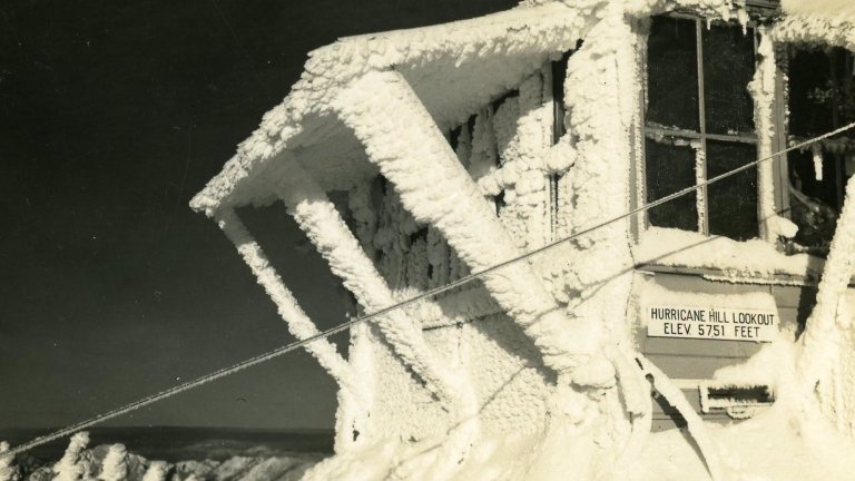 Black and white photo of ice-covered lookout post called Hurricane Hill in Olympic National Park