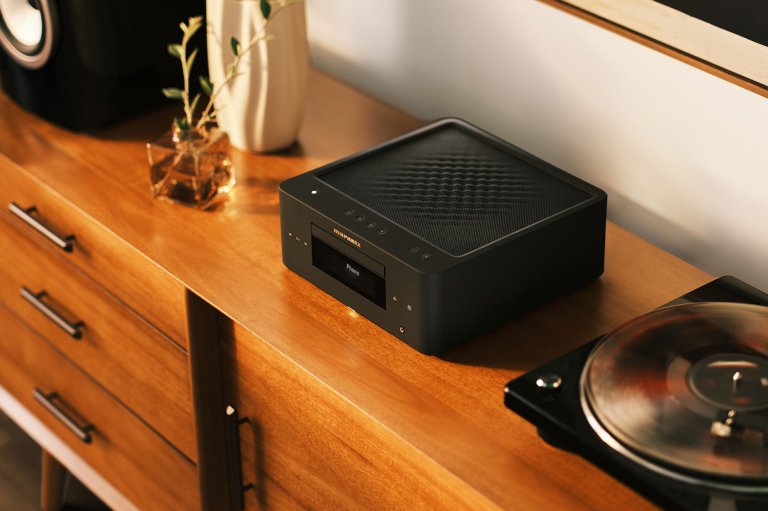 The Marantz MCR 60n streaming amplifier on a credenza with a speaker and a turntable