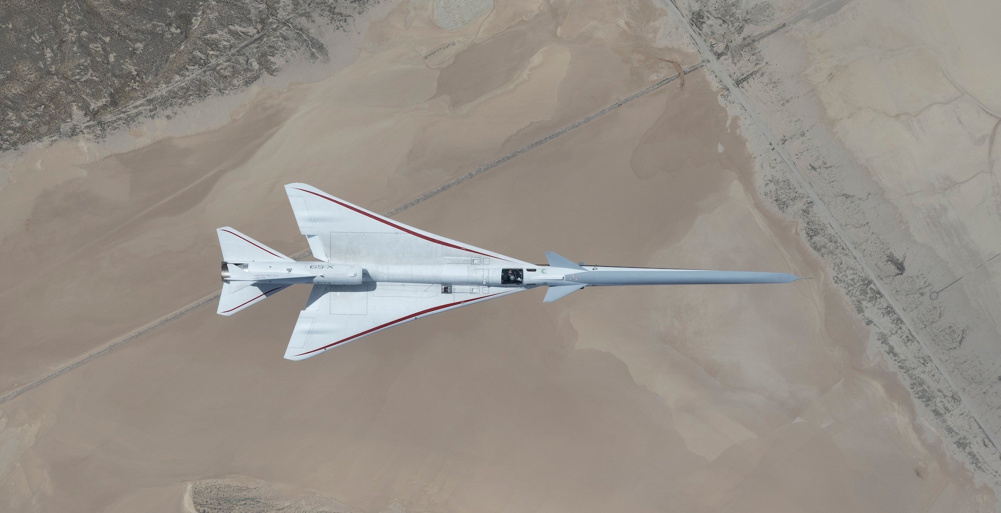 NASA’s X-59 quiet supersonic jet flies over the Mojave Desert during its third flight on Thursday, March 26, 2026, from NASA’s Armstrong Flight Research Center in Edwards, California. The aircraft departed and landed at Edwards Air Force Base, completing its approximate one-hour flight and providing the team with significant data for future flights.