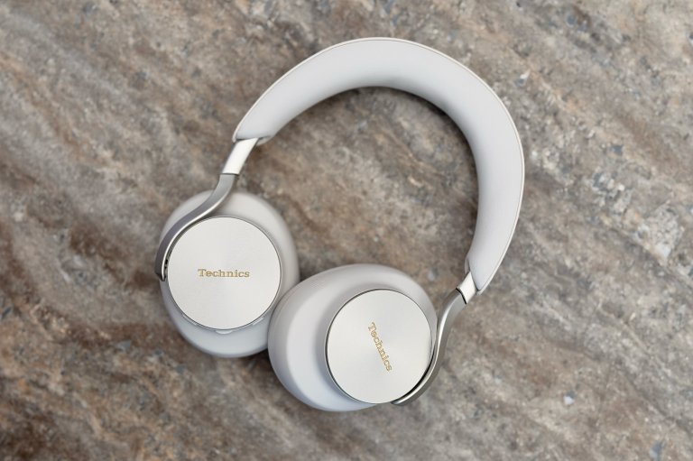 A pair of Technics EAH-A1000 flagship wireless ANC headphones shown in Platinum Greige on a marble surface