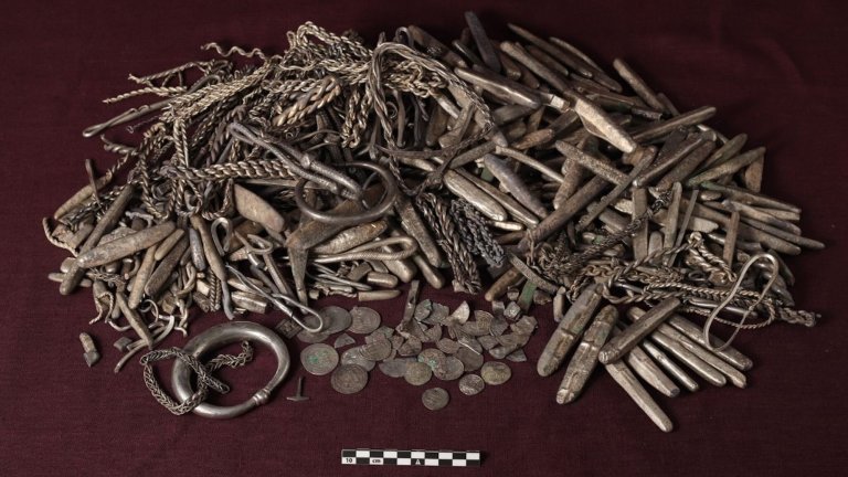 Viking silver cache discovered in Denmark that includes jewelry, bars, and coins