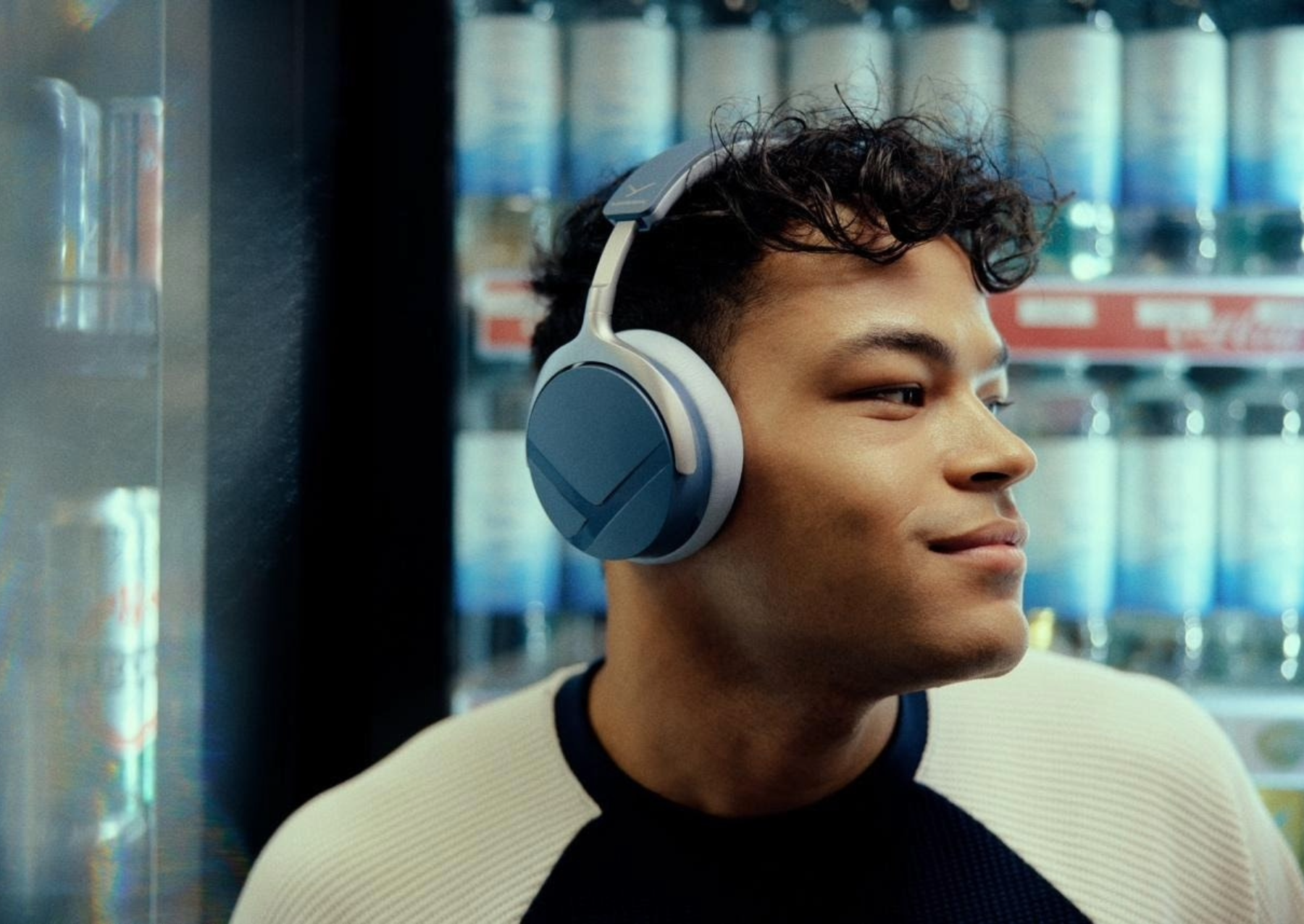 a man wearing blue-gray, over-the-ear headphones
