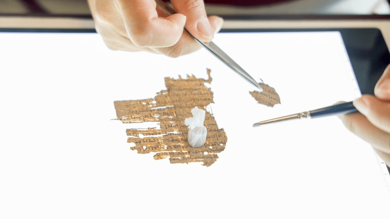 A student works with papyrus.