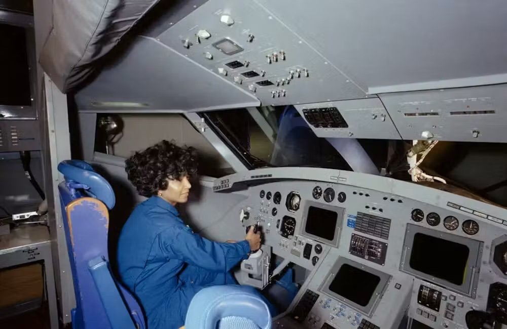 woman sits in shuttle simulator