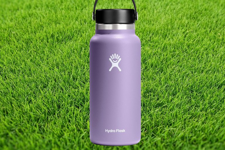 Purple Hydro Flask water bottle on grass