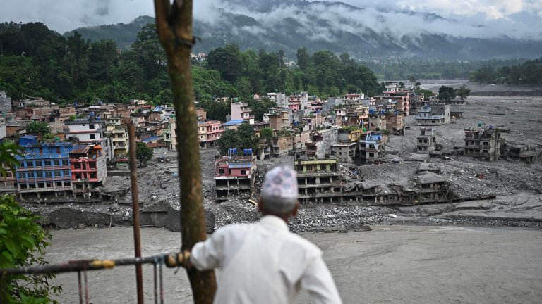A man looks at the remains in the aftermath of flash floods at Trishuli in Nepal's Nuwakot district on September 7, 2026. The August 26 glacial and mountain collapse on the China-Nepal border killed at least 1,398 people, with more than 5,500 missing, including around 800 foreigners. (Photo by Pedro PARDO / AFP)