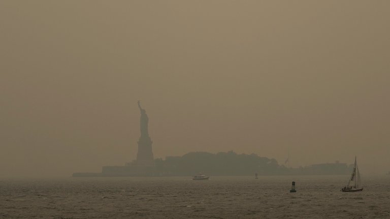 NEW YORK, NEW YORK - JULY 16: Haze from Canadian wildfires blankets the Statue of Liberty as seen from a Staten Island Ferry on July 16, 2026 in New York City. Much of the East Coast and Canada is under an Air Quality Health Advisory as the Canadian and Great Lakes wildfire smoke gradually moves through the area, creating a thick haze in the heat. The region is experiencing temperatures with heat indexes over 100 degrees as it confronts another heat wave. (Photo by David Ramos/Getty Images)