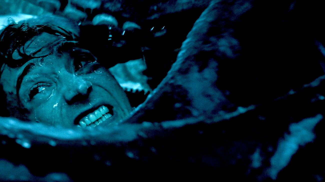 a man grits his teeth while inside of a sperm whale