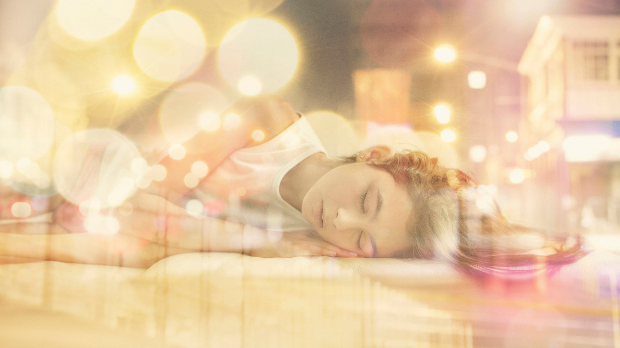 Mixed race girl dreaming of city at night
