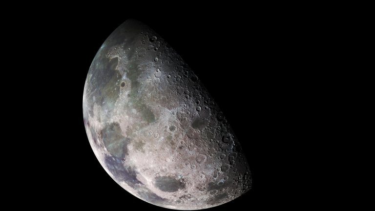 Detailed photo of the moon illuminated on one side.
