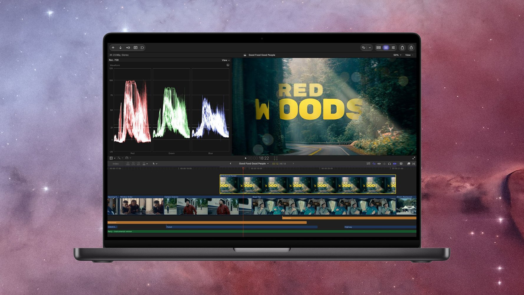Final Cut Pro on a space black MacBook Pro showing a “Red Woods” title over a forest road, with video scopes and a timeline below.