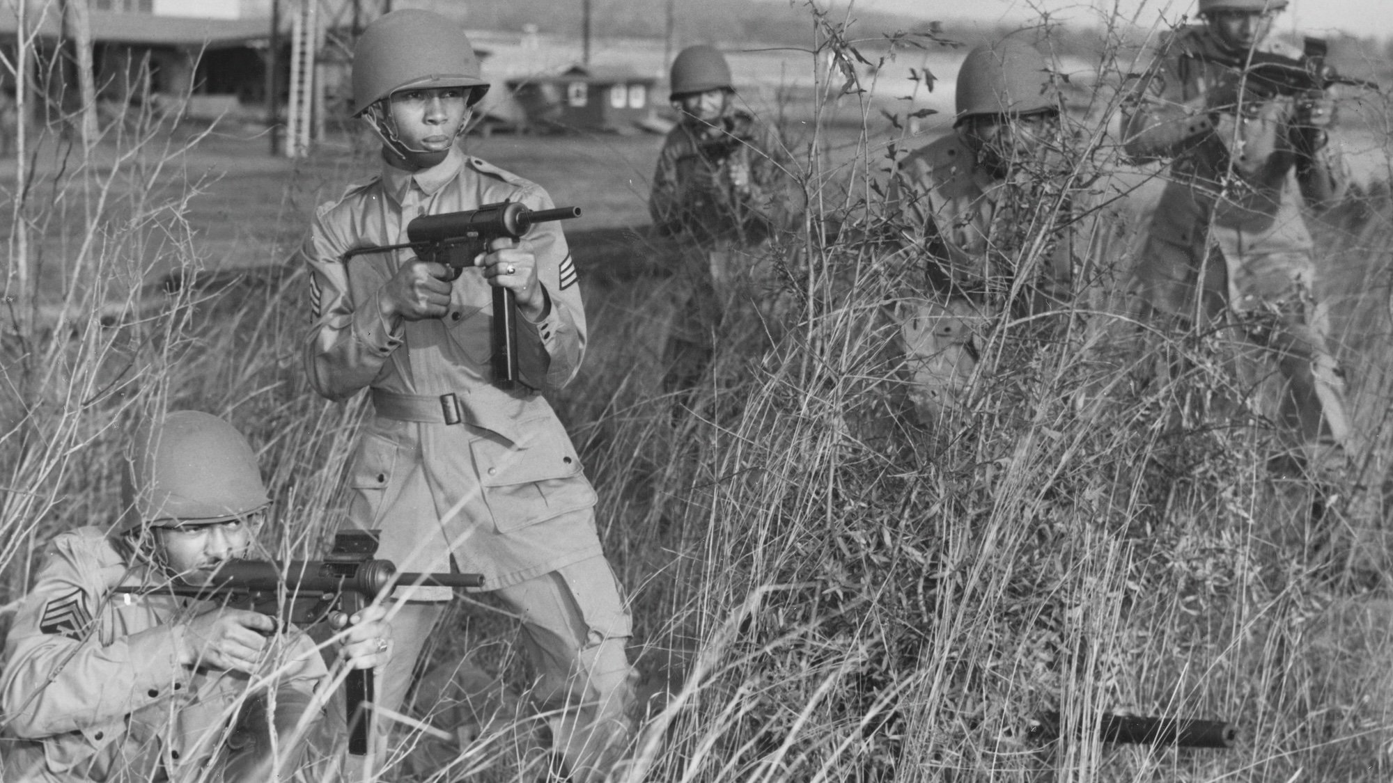 L - R, Sergeants Clarence Beavers, James Kornegay, Ned Bess, Corporal Elijah Wesby and Sergeant Alvin Moon of the United States Army All African American 555th Parachute Infantry Battalion (nicknamed the "Triple Nickles" because of its numerical designation) aim their M3 .45-caliber submachine guns, commonly referred to as the "Grease Gun" during a training exercise at Fort Benning circa February 1944 at Fort Benning, Georgia, United States. These five soldiers were part of the original 17 member selection that succeeded in becoming the first All African American parachute infantry battalion. In early 1945 the battalion were sent to Camp Pendleton in Oregon and assigned to the 9th Services Command, trained by the U.S. Forest Service, and became history's first military airborne firefighting smokejumpers. (Photo by INP/Bettmann Archive/Getty Images)