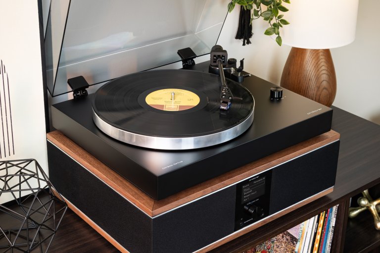 A matte black Andover-One DD Turntable sitting on top of an Andover-One SB speaker base