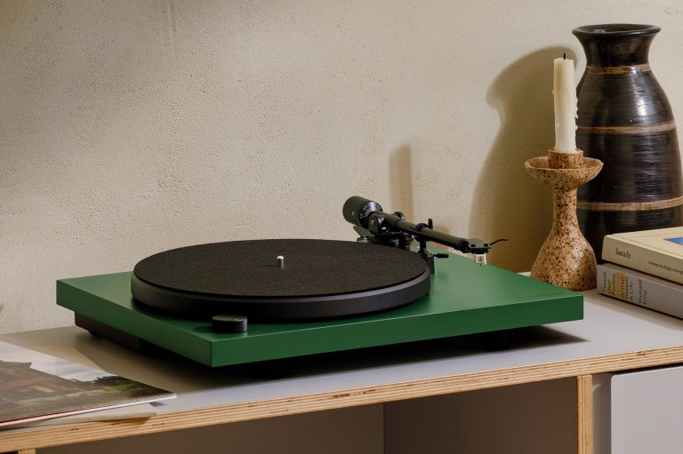 A green Cambridge Audio Spira turntable sitting on a countertop