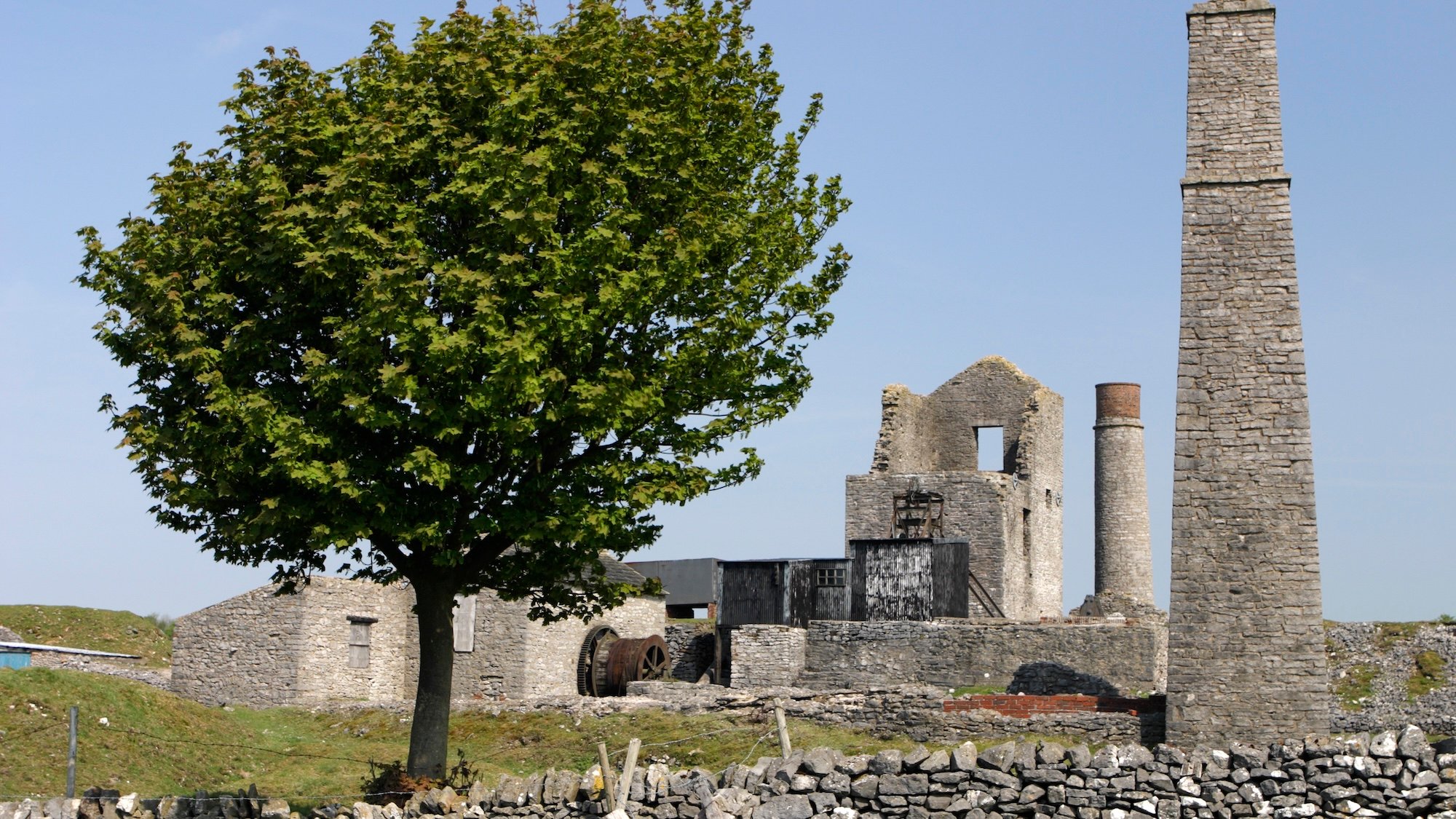 Magpie Mine, Derbyshire. Magpie Mine, near the village of Sheldon in the Peak District, is an old lead mine. It was first worked in around 1740 but closed for the last time in 1954, although it only operated intermittently from 1835 onwards. It reached the peak of its production in the 1820s after a Newcomen pumping engine was installed to keep the workings free of water. The mine became notoious in 1833 after 24 of its miners were put on trial for murder. The Magpie men and those of the nearby Maypitt mine were both working on the same disputed seam of ore underground, and would light fires in order to try to smoke each other out. One such incident led to three Maypitt miners dying after being overcome by fumes. None of the Magpie workers were convicted, partly owing to the difficulty of ascertaining which individuals were actually responsible. It is said that the widows of the dead Maypitt men laid a curse on the Magpie Mine, leading to its ruin. (Photo by Peter Thompson/Heritage Images/Getty Images)