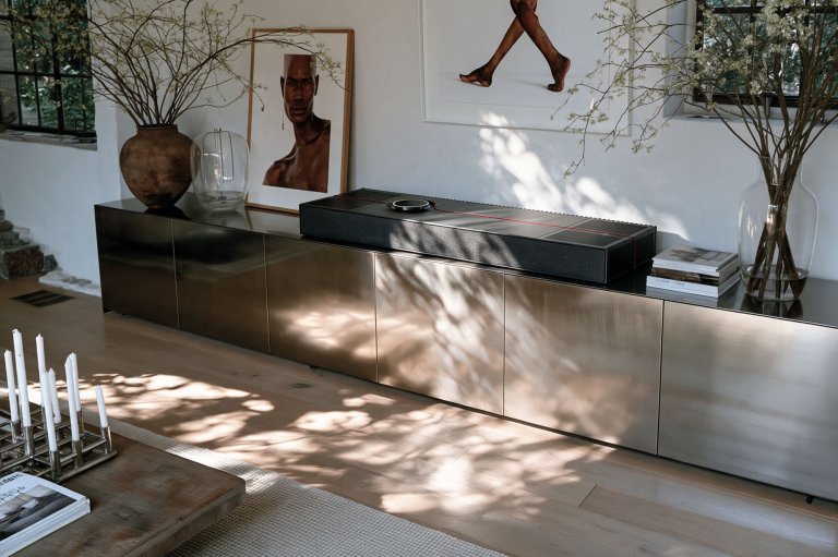 A Focal-Naim Mu-so Utopia sitting on top of a credenza in a modern home